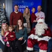 Two families with pose with Santa